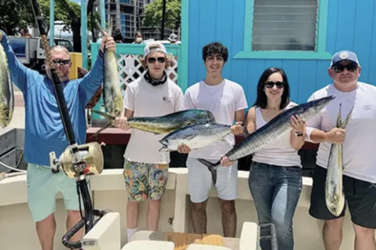 a group of people standing in front of a fish