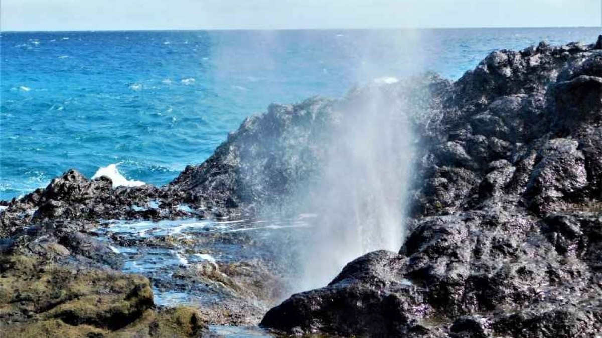 a waterfall going over a body of water