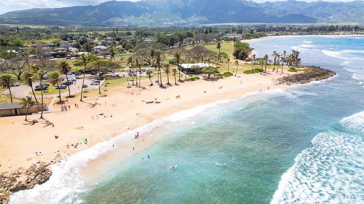 a group of people on a beach near a body of water