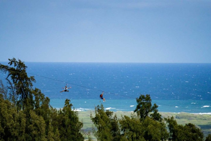 a man flying through the air over a body of water