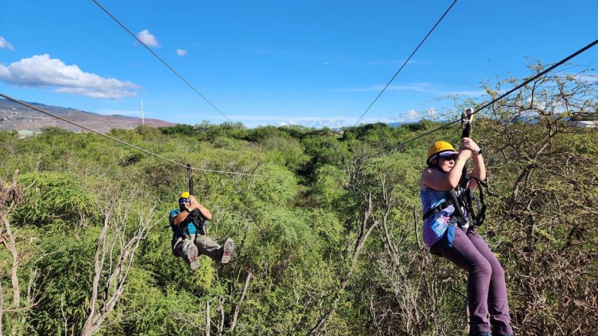a man flying through the air while riding a bike down a dirt road