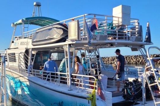 a group of people in a boat docked next to a body of water