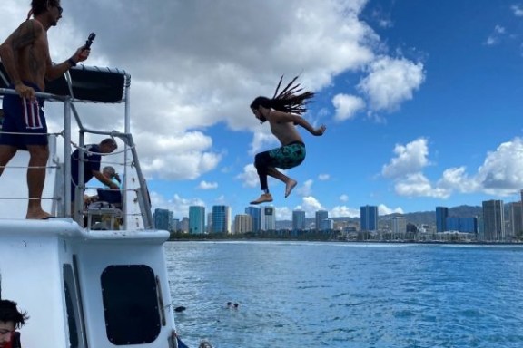 a group of people on a boat in the water