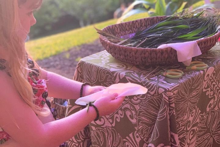 a woman sitting at a table with a cake