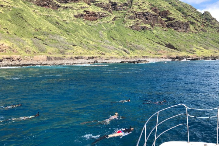 a body of water with a mountain in the background