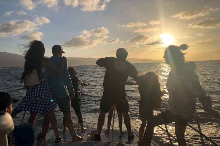 a group of people standing on a beach