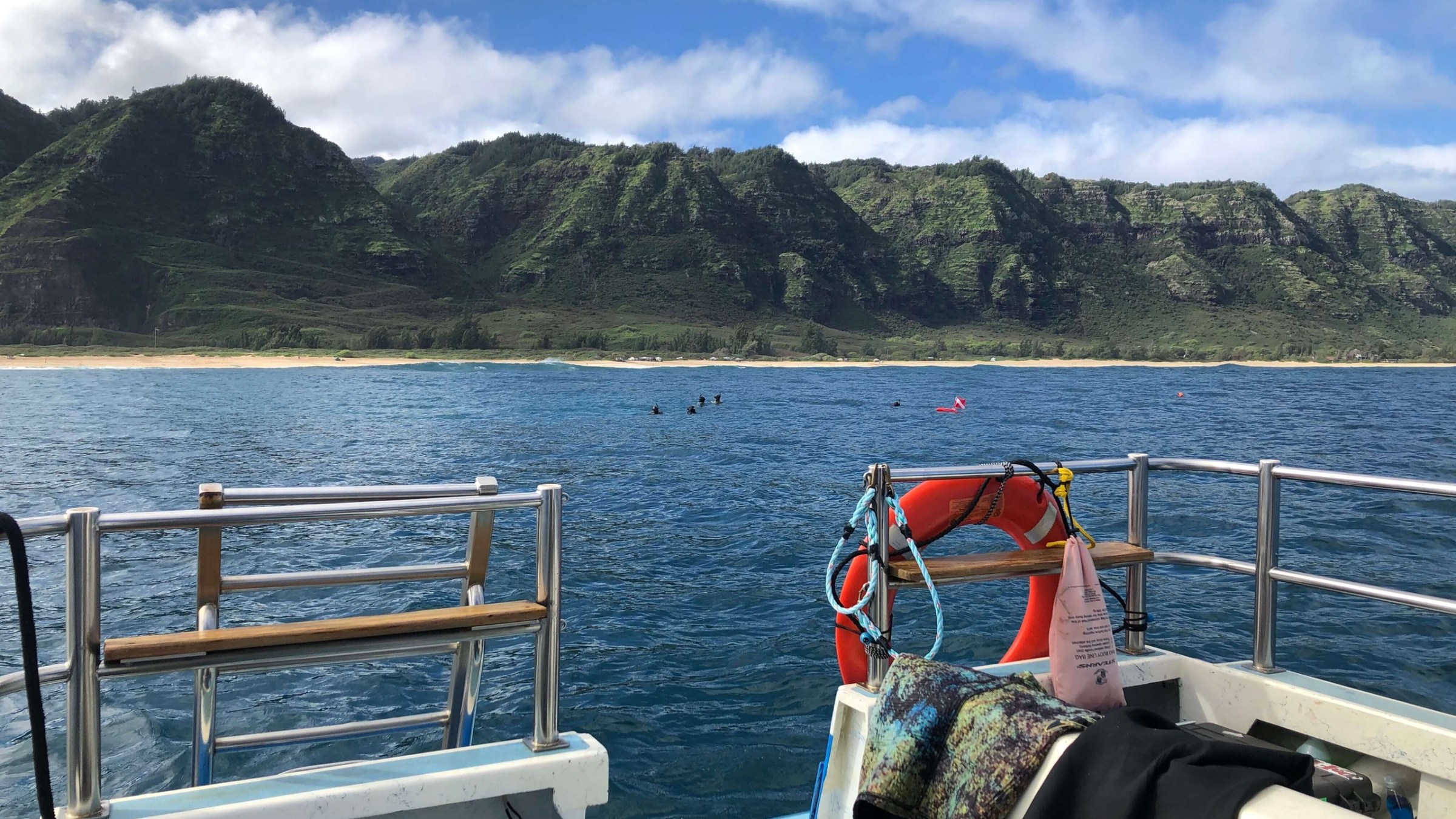 a boat that is sitting on a bench next to a body of water