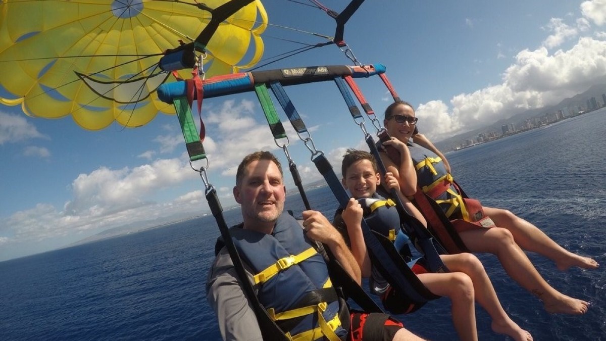 a person holding a kite in a boat on a body of water
