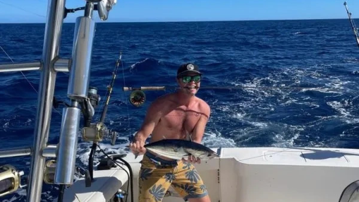 a man sitting on a boat in the water
