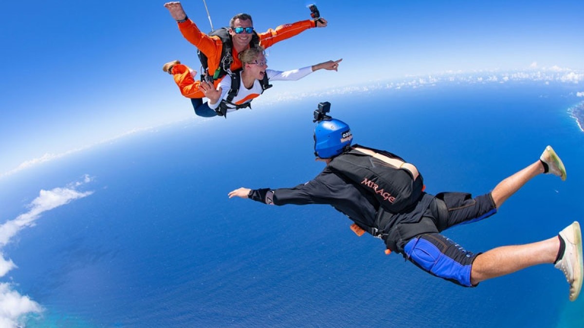 a person jumping in the air doing a trick on a skateboard