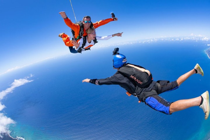 a person jumping in the air doing a trick on a skateboard