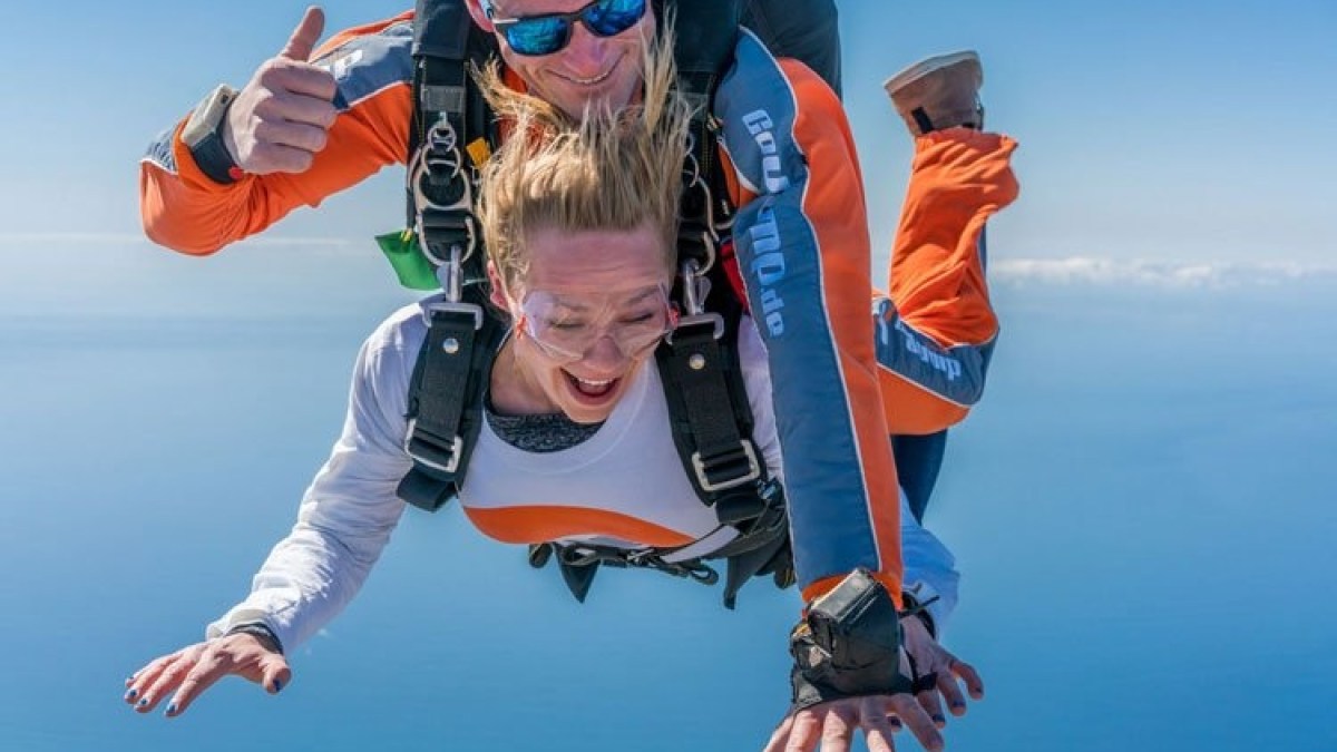 a person flying through the air while swimming in a body of water