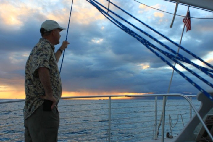 a man standing next to a body of water