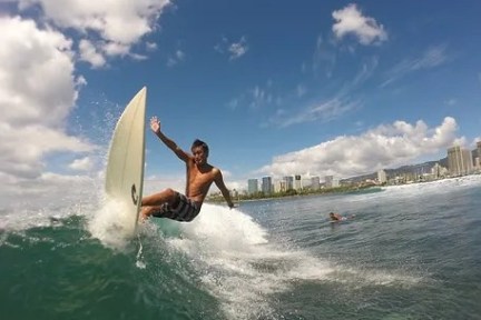 a man riding a wave on a surfboard in the ocean