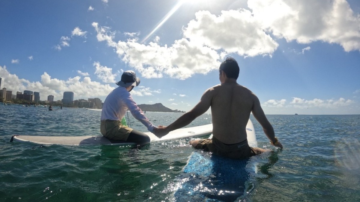 a man riding a wave on top of a body of water