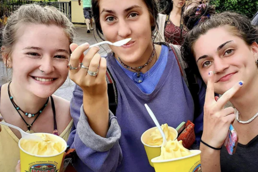 a little girl eating a hot dog