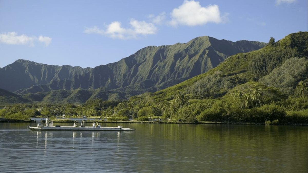 a body of water with a mountain in the background