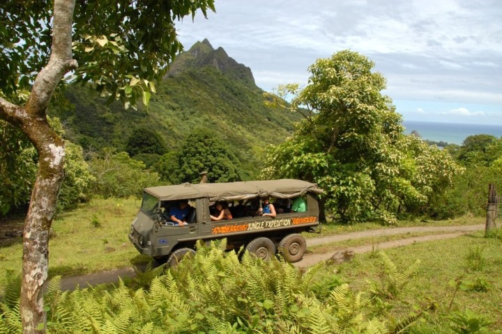 a truck driving down a dirt road