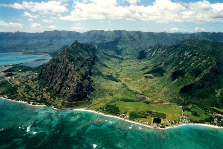 a body of water with a mountain in the background