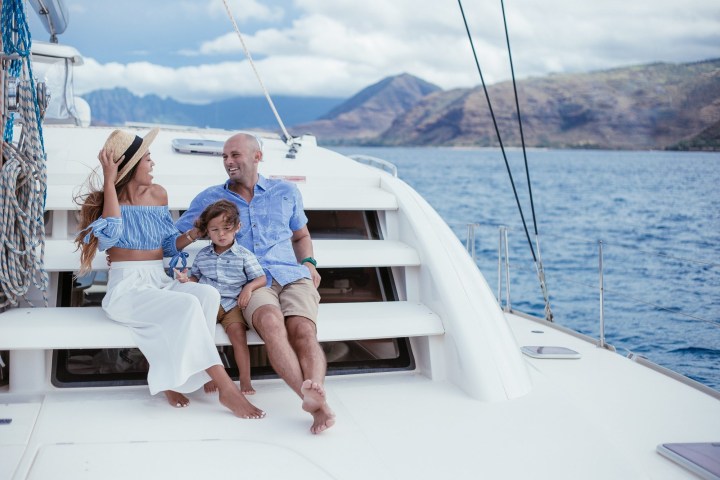 a man and a woman sitting on a boat in the water