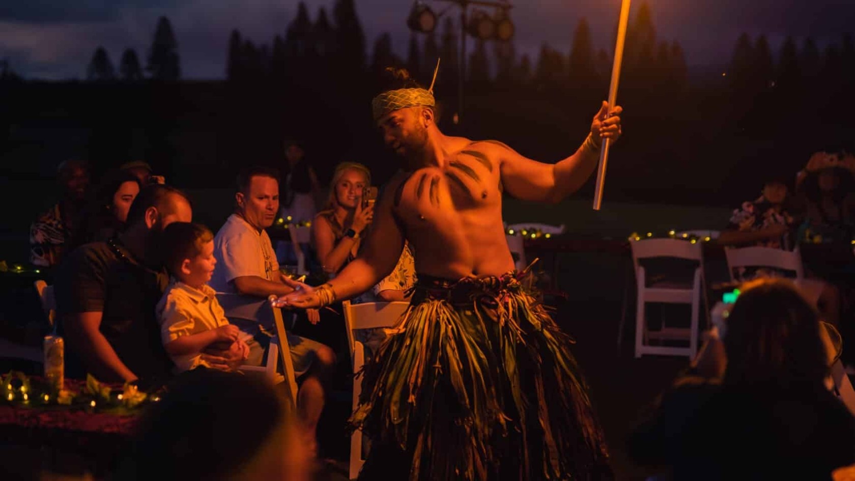 a group of people standing around a fire