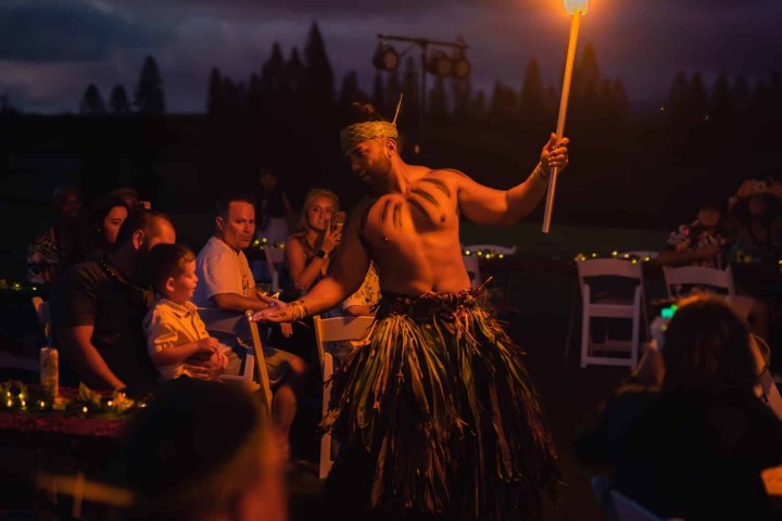 a group of people standing around a fire