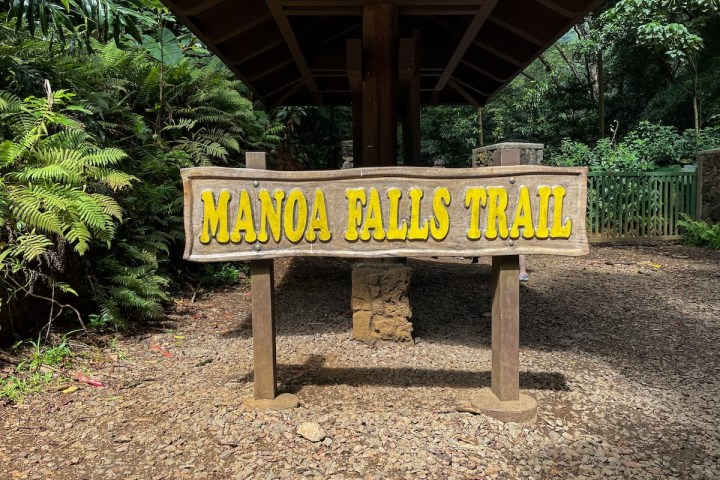 a sign on a wooden bench