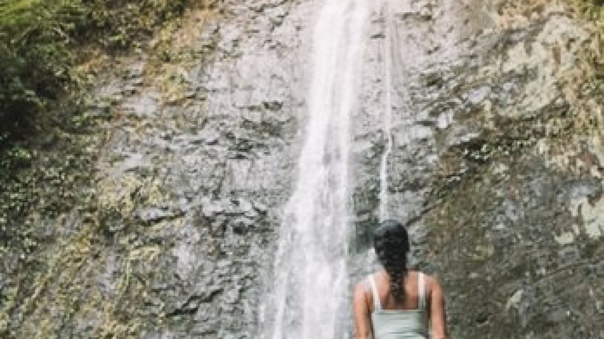 a person standing next to a waterfall