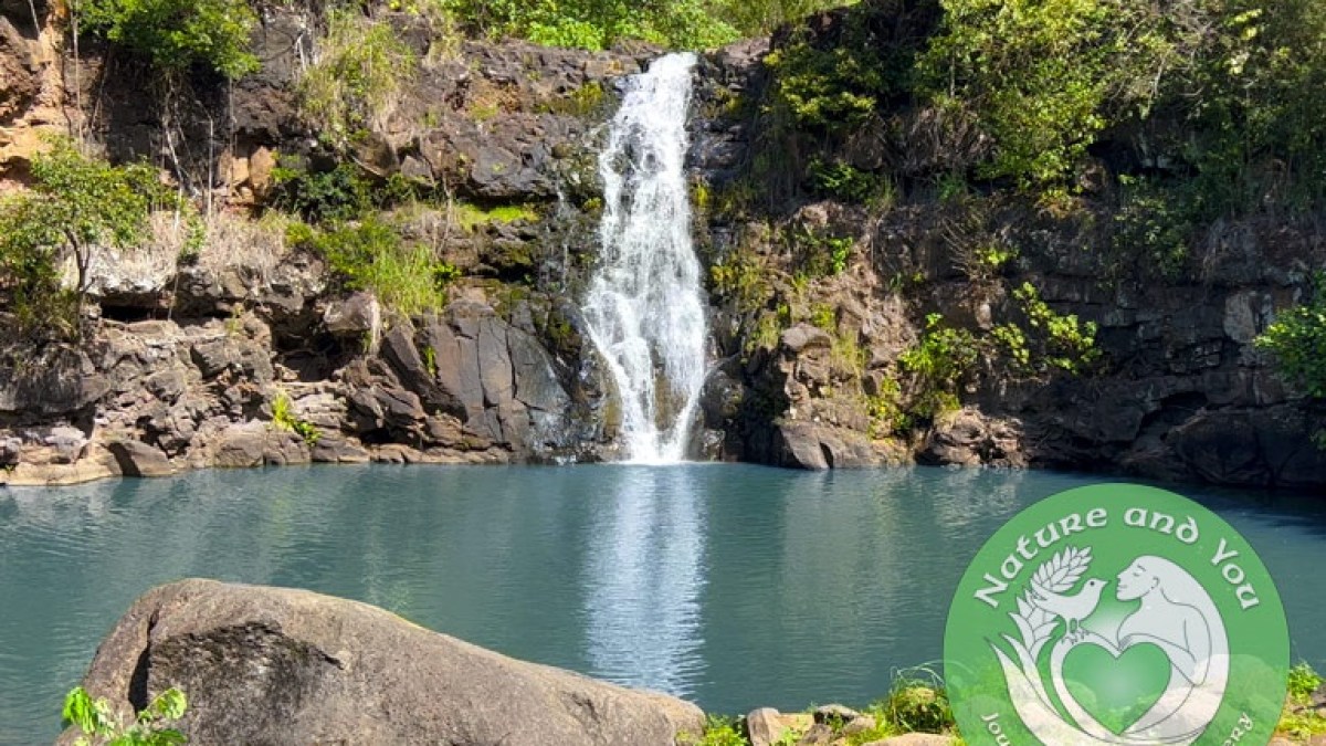 a large waterfall in front of a lake
