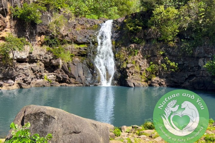 a large waterfall in front of a lake