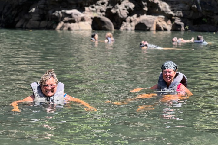 a group of people riding skis on a body of water