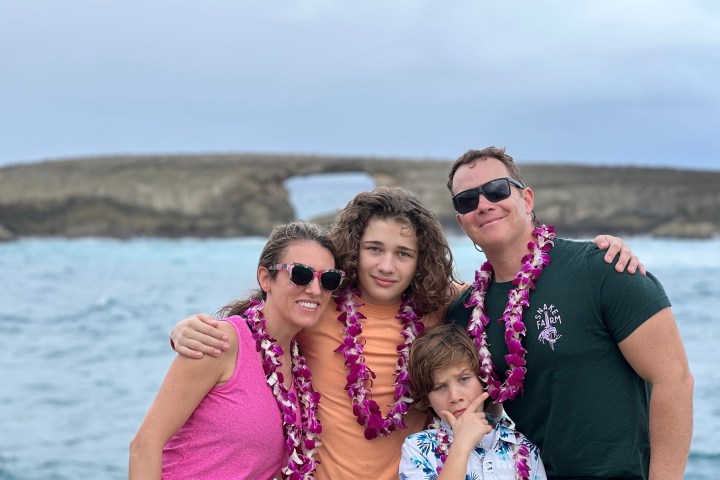 a person standing next to a body of water