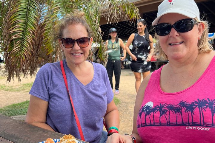 a person standing in front of a palm tree