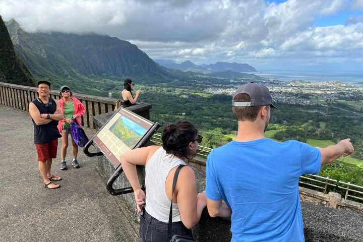 a group of people standing on top of a mountain