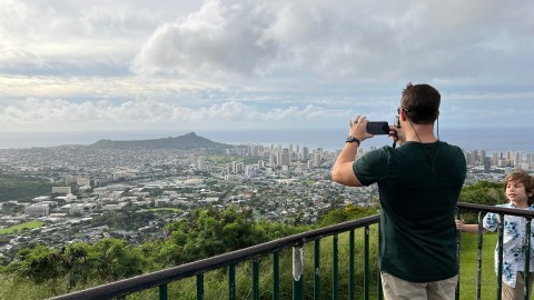 a person standing in front of a fence