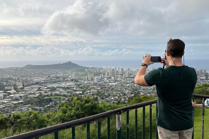 a person standing in front of a fence