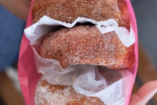 a hand holding a piece of cake