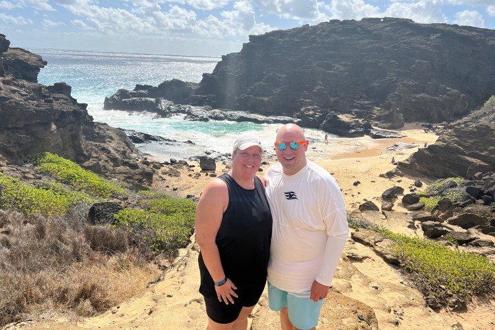 a man standing in front of a mountain