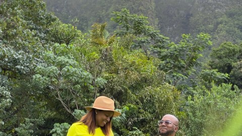 a couple of people that are standing in the grass