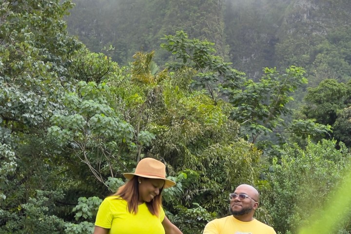 a couple of people that are standing in the grass