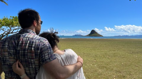 a man that is standing in the grass