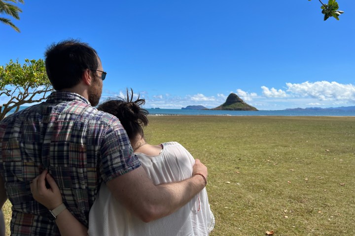 a man that is standing in the grass