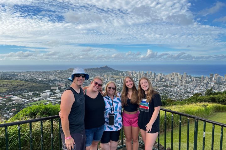 a group of people standing next to a body of water