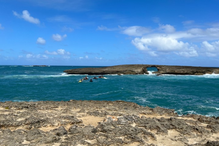 a sandy beach next to the ocean