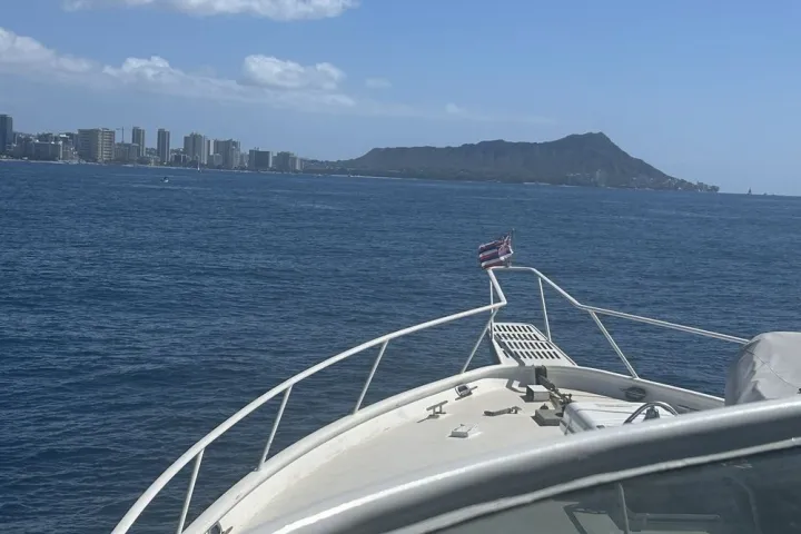 a close up of a boat next to a body of water