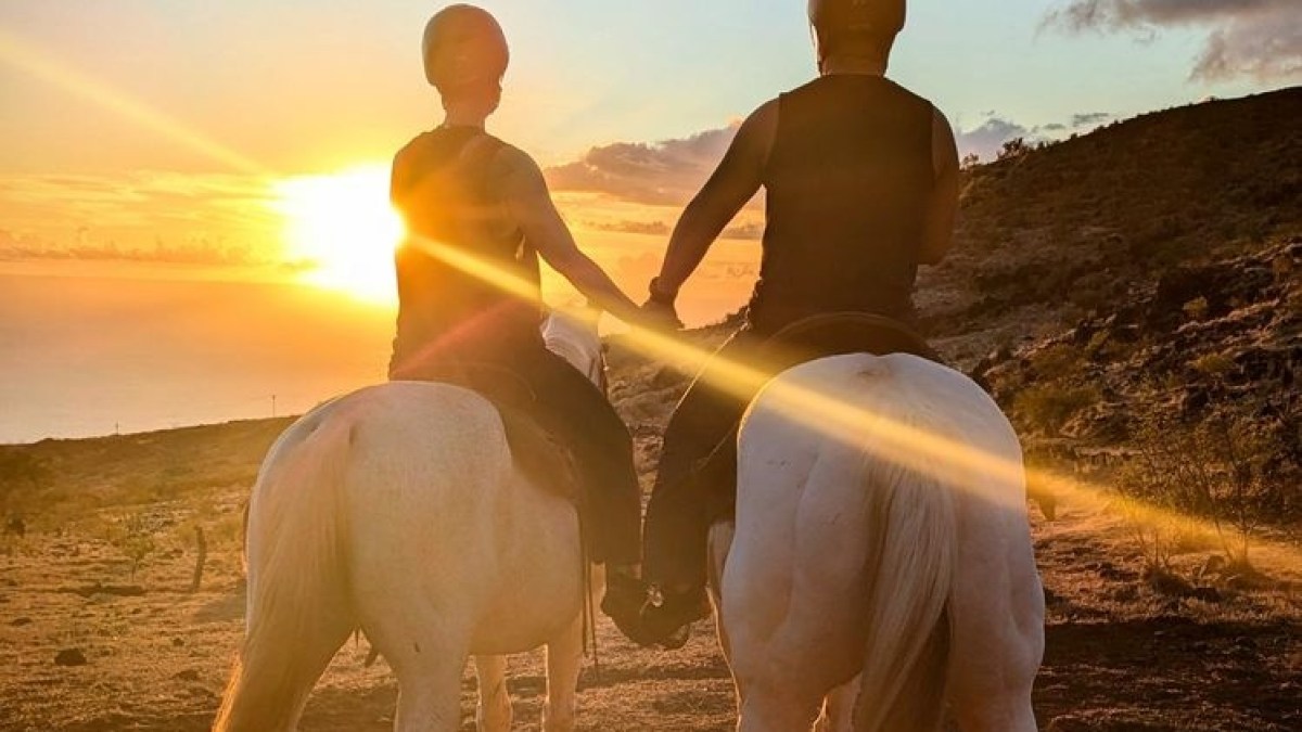 a man riding a horse on a beach