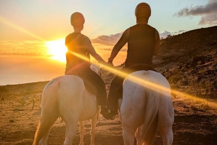 a man riding a horse on a beach