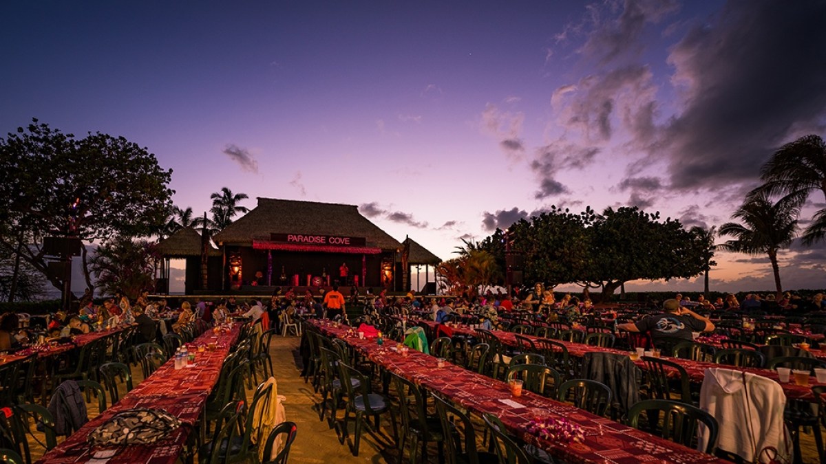 a group of people standing in a parking lot