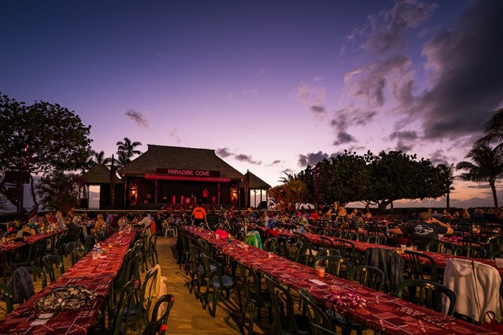 a group of people standing in a parking lot