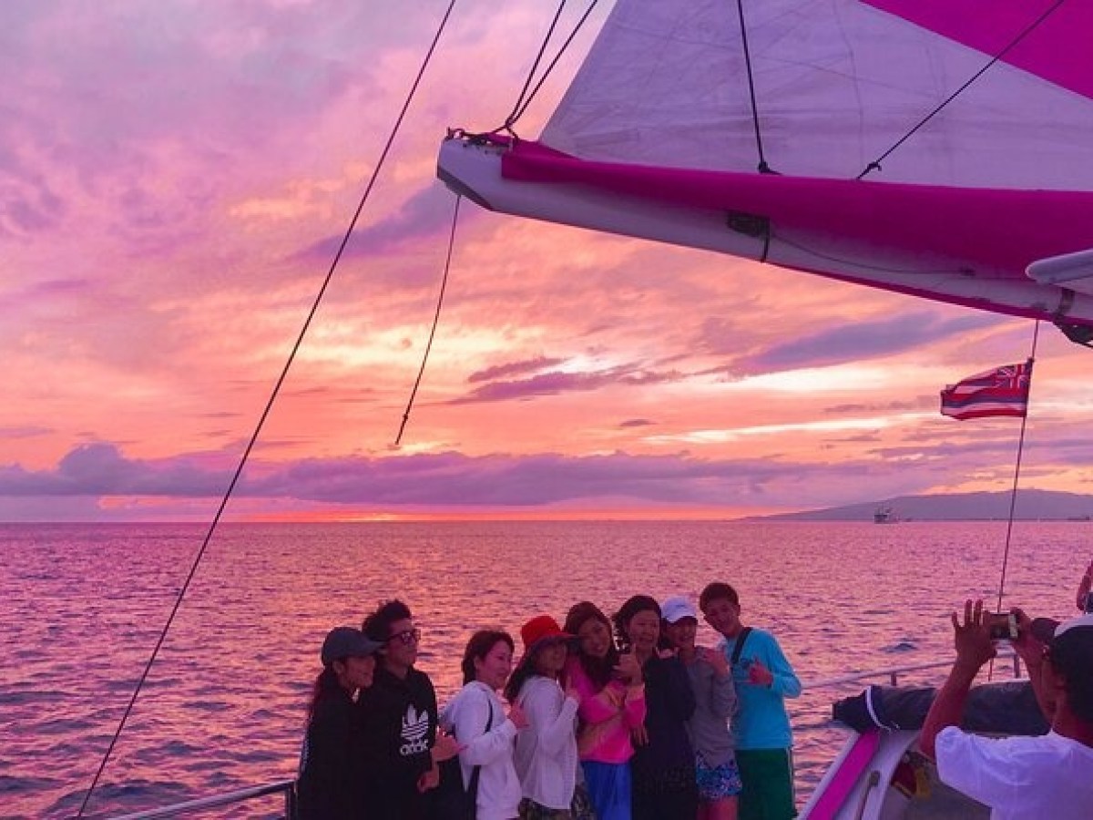 a group of people on a boat in a large body of water